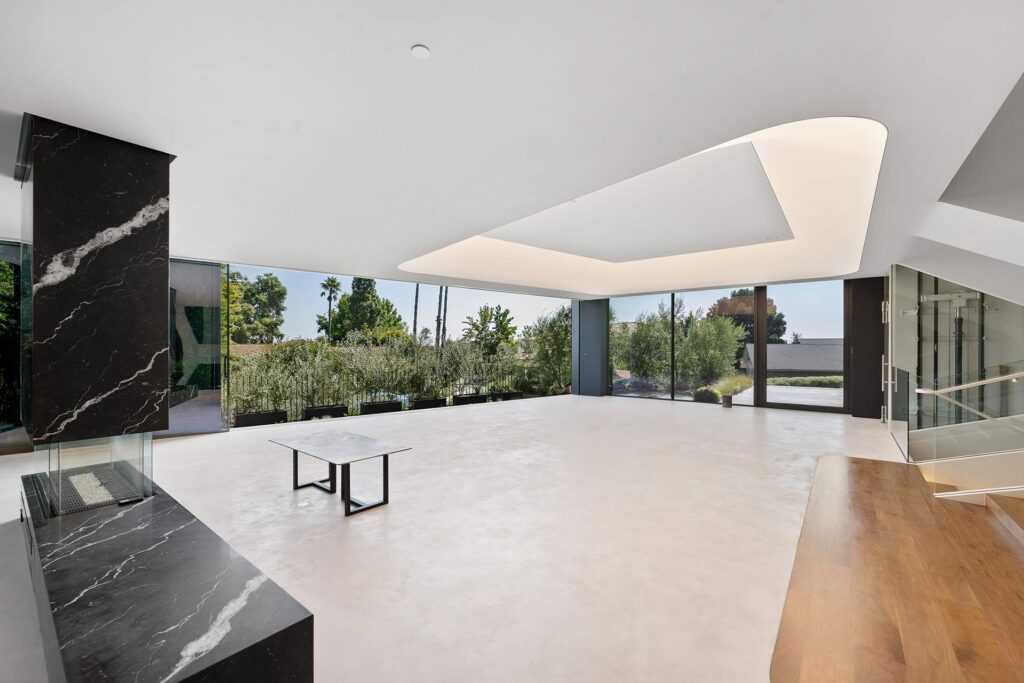 Modern living space with white walls and black marble, featured by trusted real estate agents in the United States